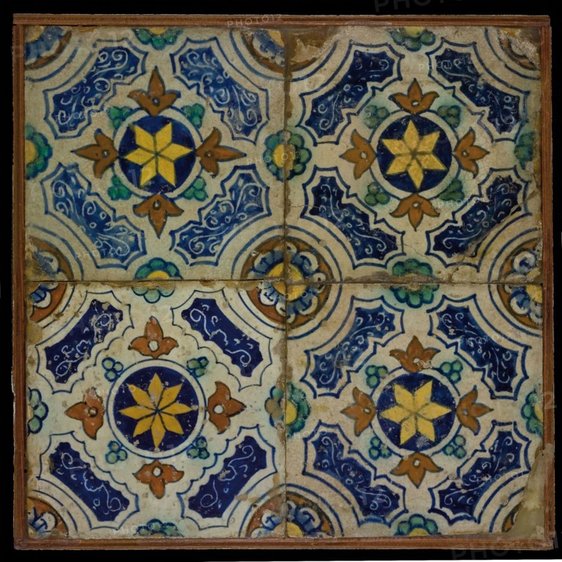 Tile field, four tiles, blue, yellow, orange and green on white, central yellow star in circle, sgraffito surfaces, corner motif