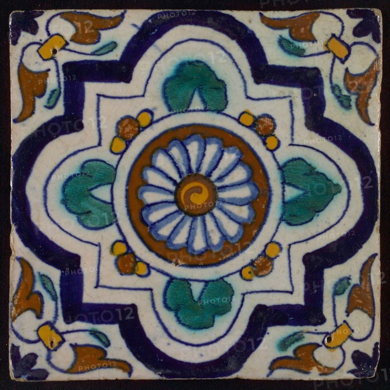 Ornament tile, blue, green and brown on white, central rosette with four-step variant frame, corner motif, wing, wall tile