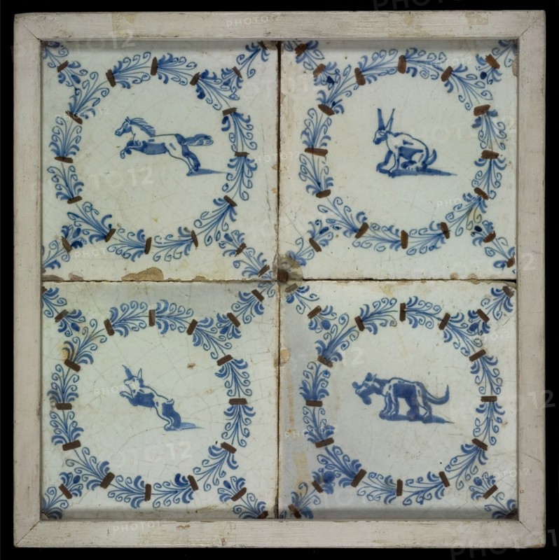 Tile field, four tiles with animal decor, blue and brown on white, one with horse and three others with dog, all in egret