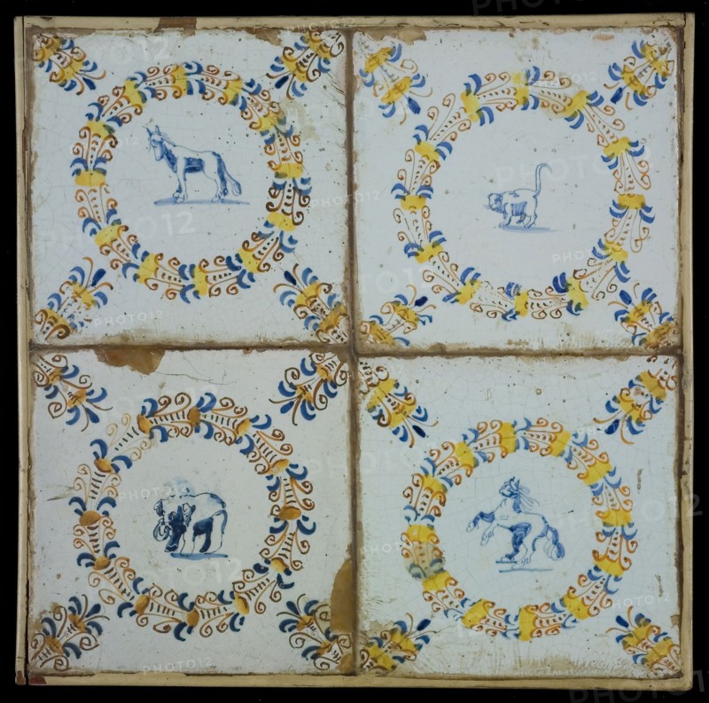 Tile field, four tiles, animal decor in egret, with yellow, orange, blue and brown on white, two horses, elephant and cat-like