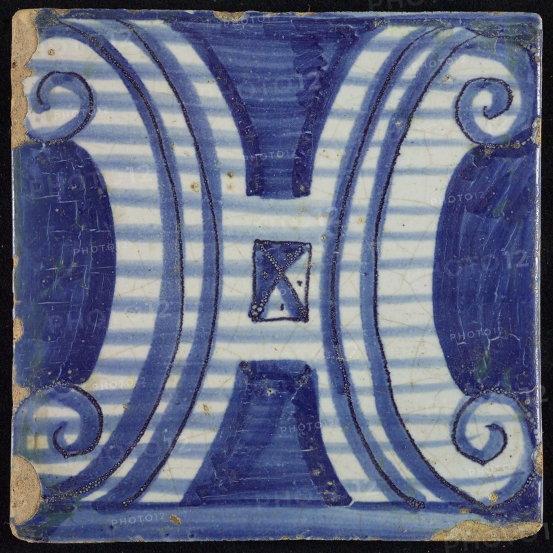 Tile of chimney pilaster, blue on white, part of pillar with capitals in H-shaped curly ornament, chimney pilaster tile pilaster