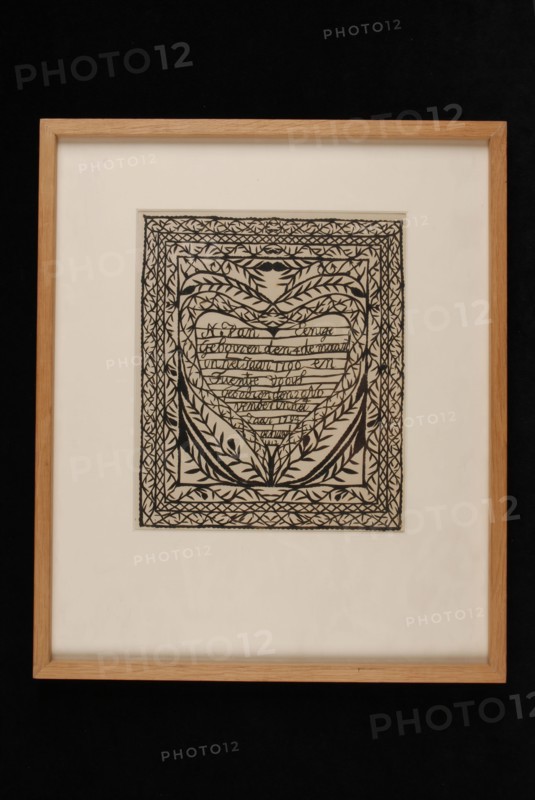 Cutting art of black paper on white ground, with text in heart shape about N. Van Eenige and Tuentje Vooys, married in 1812