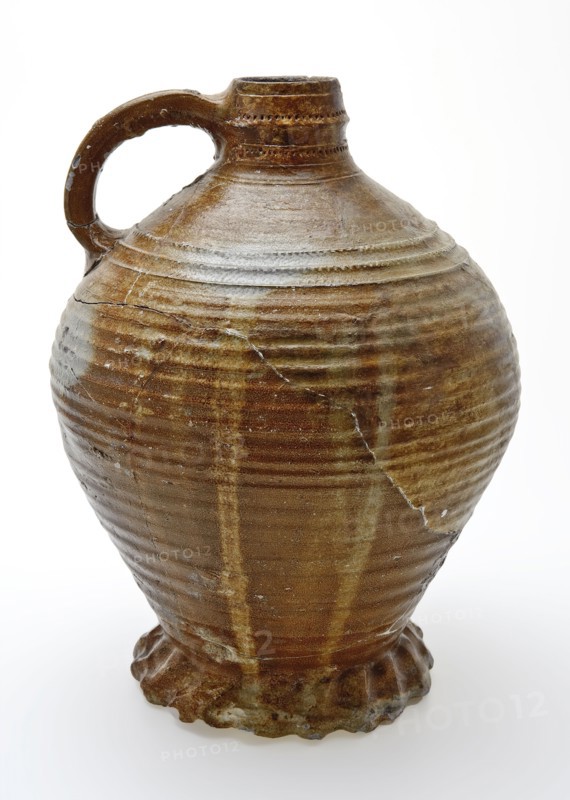 Large stoneware jug on heavy pinched foot, radstamp decoration around neck and shoulder, jug holder kitchen utensils earthenware