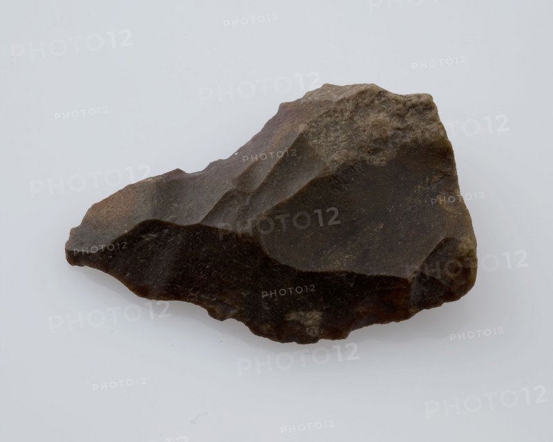 Flint point, or flare of brown flint, point artifact founding flint, mined Small point of flint from the stone age or bronze age