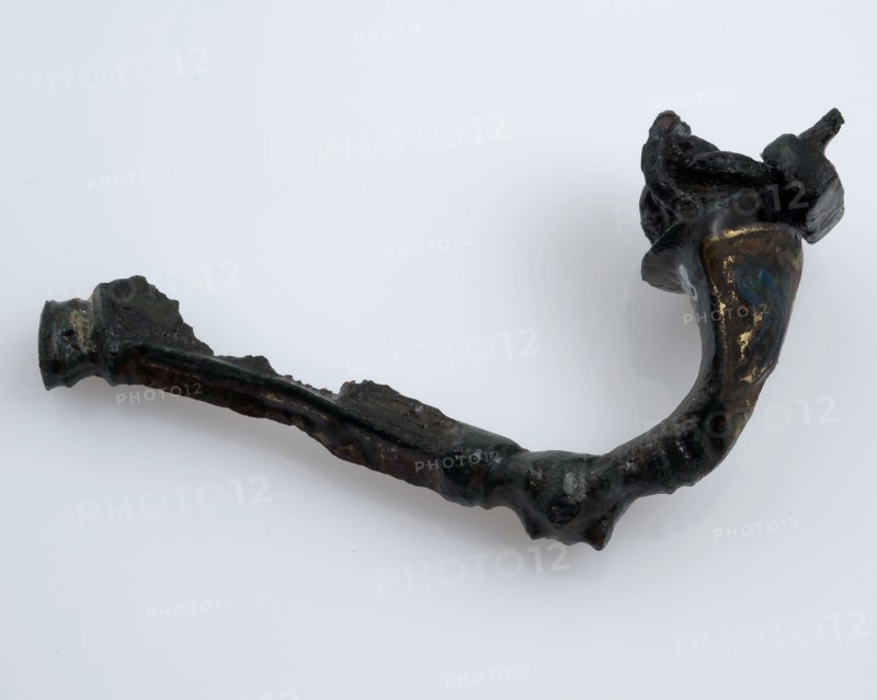 Bronze fibula or mantle pin decorated with enamel, part of the needle remains, fibula fastener soil find bronze metal enamel