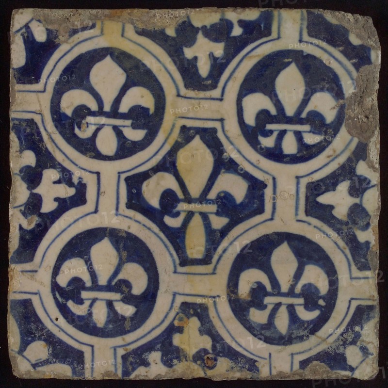 Two-tone tile, blue on white background, four circles with white French lily around central ornament with lily, wall tile