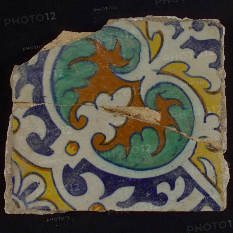 Ornament tile, central kidney-shaped green and brown floral shape, corner motifs, quarter rosette and save technique, wall tile
