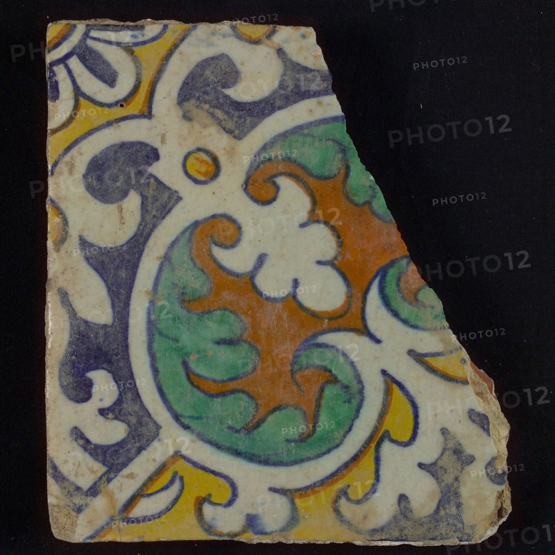 Ornament tile, central kidney-shaped green and brown floral shape, corner motifs, quarter rosette and save technique, wall tile