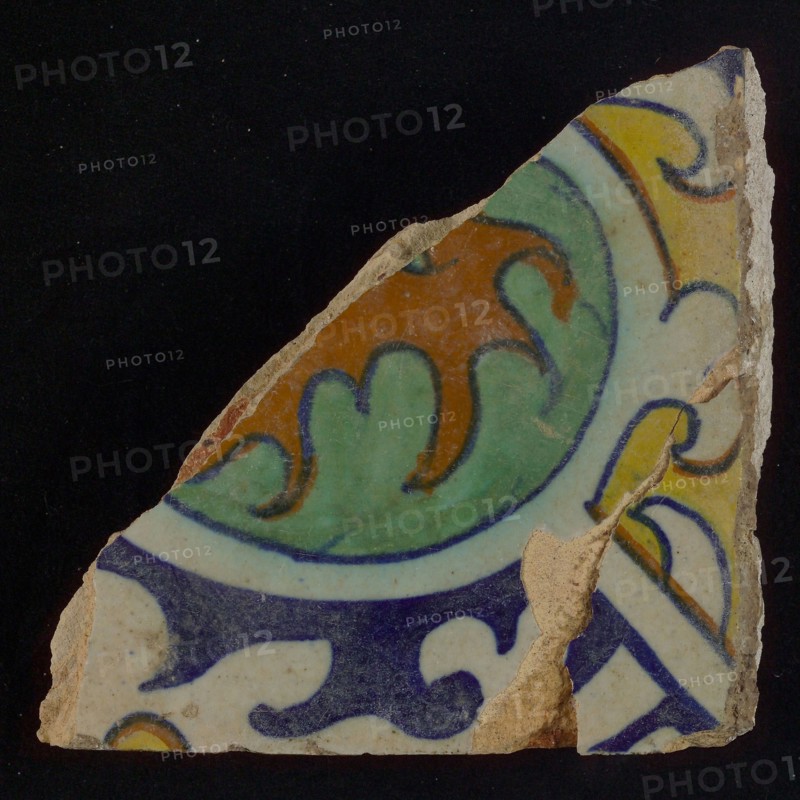 Ornament tile, central kidney-shaped green and brown floral shape, corner motifs, quarter rosette and save technique, wall tile