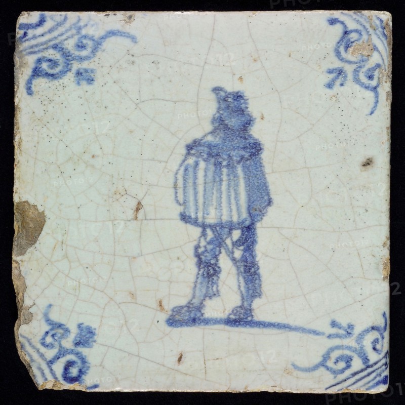 GA (?), Figure tile, man with short coat, blue decor on white ground, corner fill: ox head, marked, wall tile tile sculpture