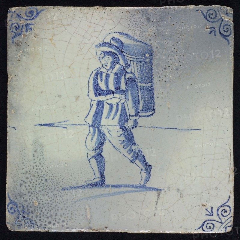 QJ, Figure tile, man with basket and spear, blue decor on white ground, corner fill: ox head, marked, wall tile tile sculpture