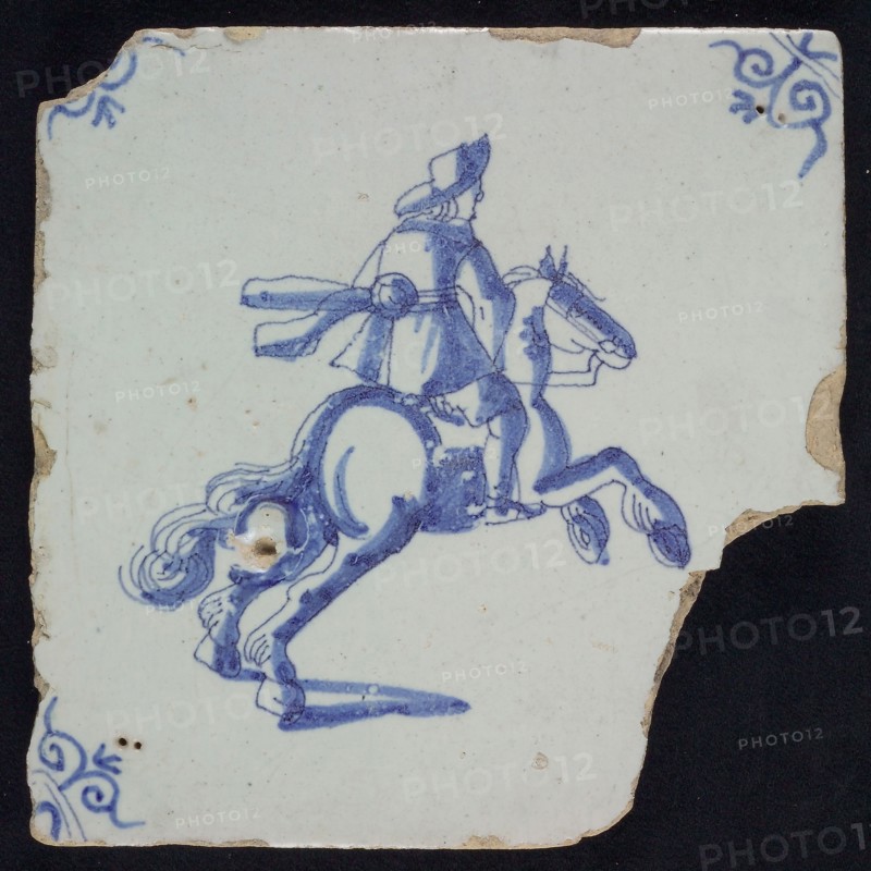 IK, Figure tile, rider on rearing horse, blue decor on white ground, corner filling: ox head, marked, wall tile tile sculpture