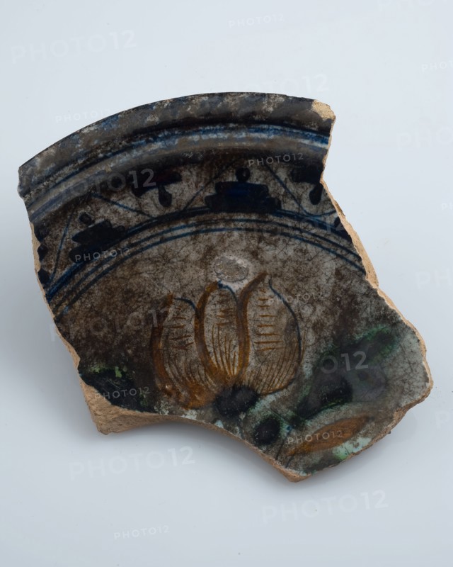 Fragment of majolica dish, polychrome three-tier or flower vase in the mirror, plate crockery holder soil find ceramic