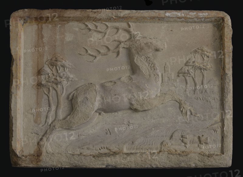 Facing brick with over brook jumping deer in landscape with trees and gate, facing stone sculpture sculpture building component