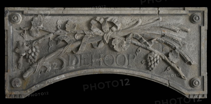 Foundation stone of distillery, with grape vines, ears of corn and text De Hoop, facing stone first stone sculpture sculpture