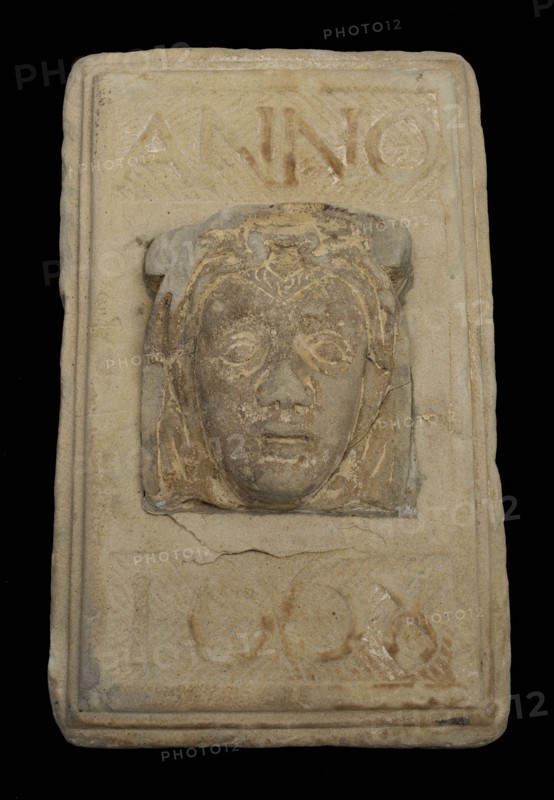 Facing brick with woman's head and text in 1668, facing stone sculpture sculpture building component sandstone stone, sculpted