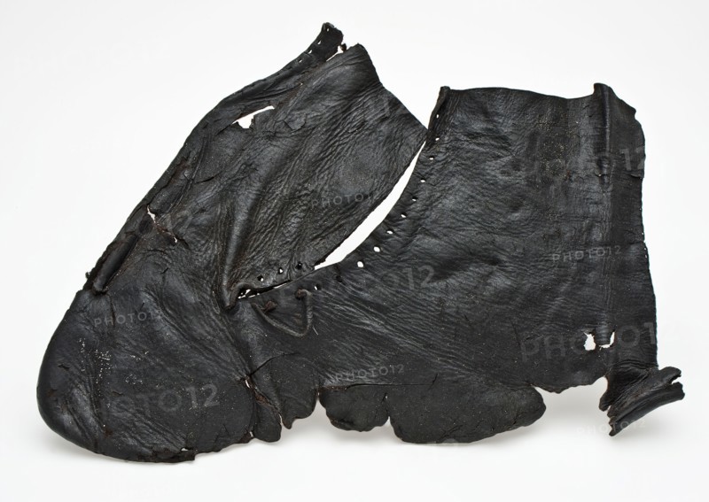 One piece cut upper piece of shoe or half boot with round holes and part of leather lace, shoe footwear clothing soil finding