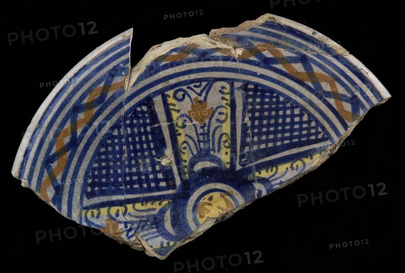 Fragment majolica dish, yellow, orange and blue on white, cross shape with shaded areas in between, dish plate crockery holder