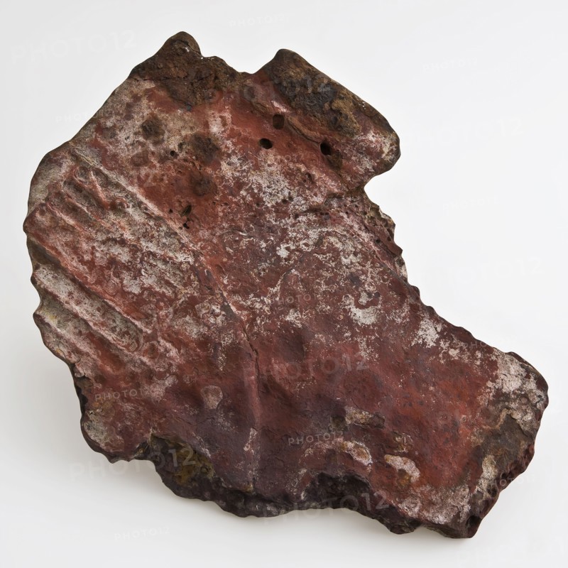 Fragment of an iron hob or stove, fireback soil found iron metal, cast Flat piece of metal. Irregular in shape. Surface provided