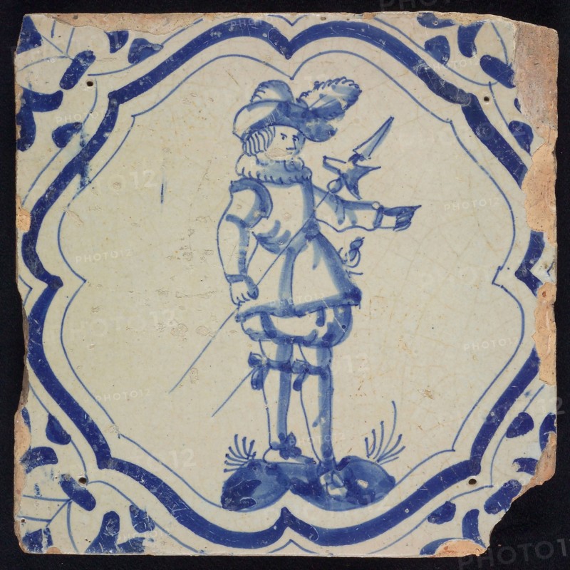 FI of EI of FL (?), Figure tile, blue on white, warrior on ground inside frame with braces, corner motif, wall tile