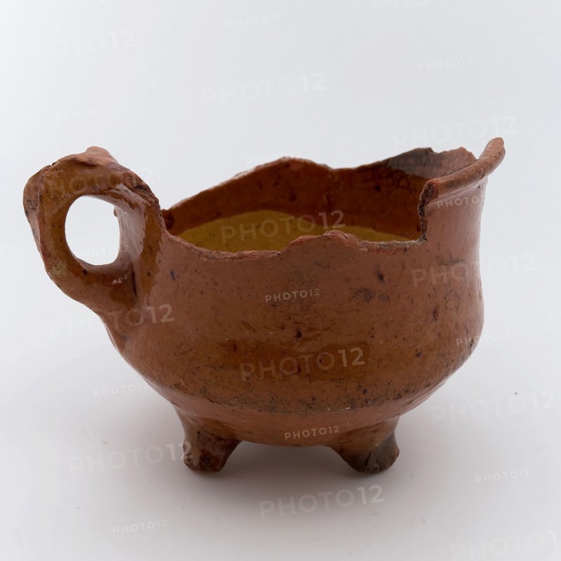 Fragment earthenware cooking jug, completely lacquered in yellow and brown, on three legs, cooking jug
