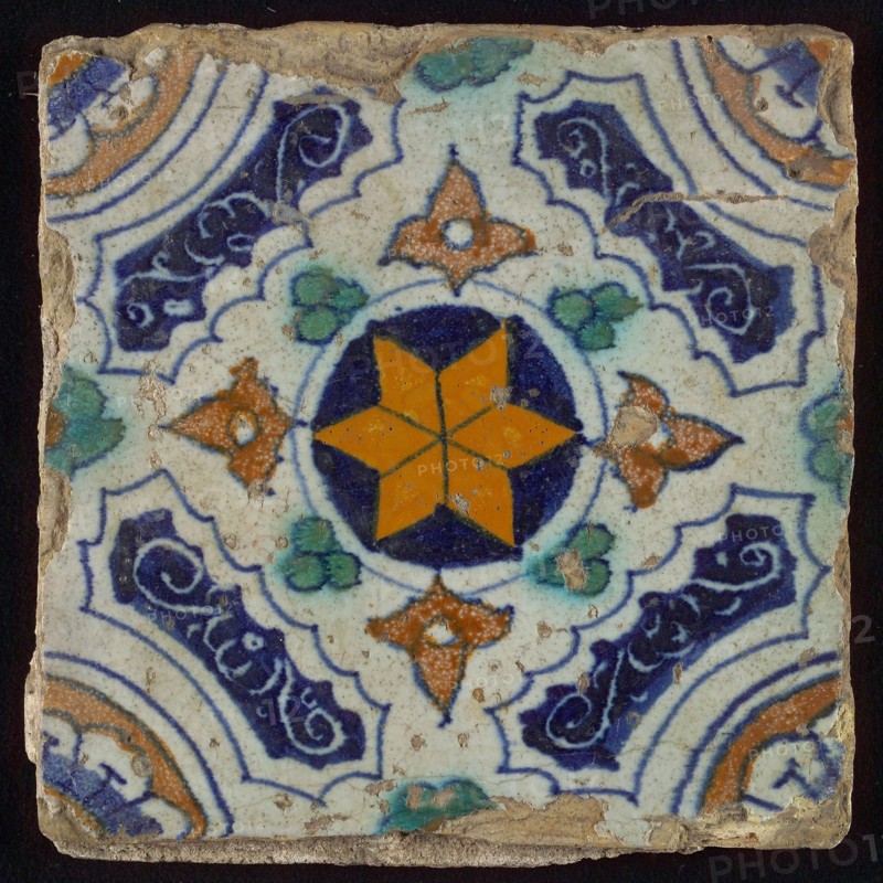 Tile, blue, green, brown and yellow on white, central an orange star in circle, sgraffito surfaces, corner motif quarter rosette