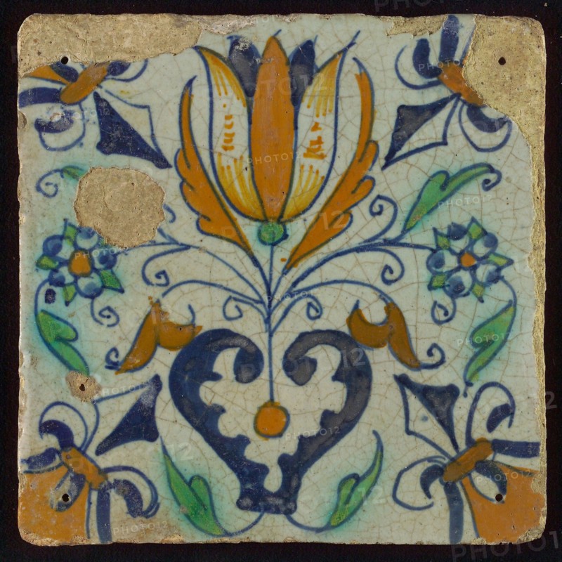 Tile, blue draft, orange, brown and green on white, centrally tulip and heart, corner motif lily, wall tile tile material