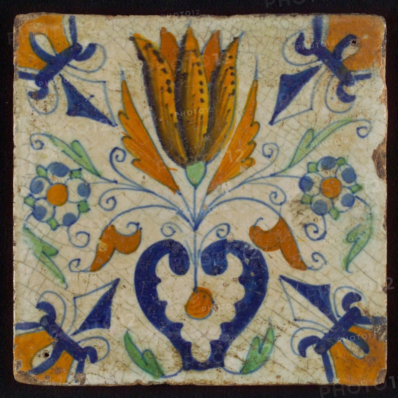 Tile, blue draft, brown, orange and green on white, centrally tulip and heart, corner motif lily, wall tile tile sculpture