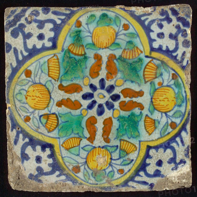 Ornament tile, centrally rosette above which orange-pineapples and marigolds, four-sided frame, corner motif, wall tile