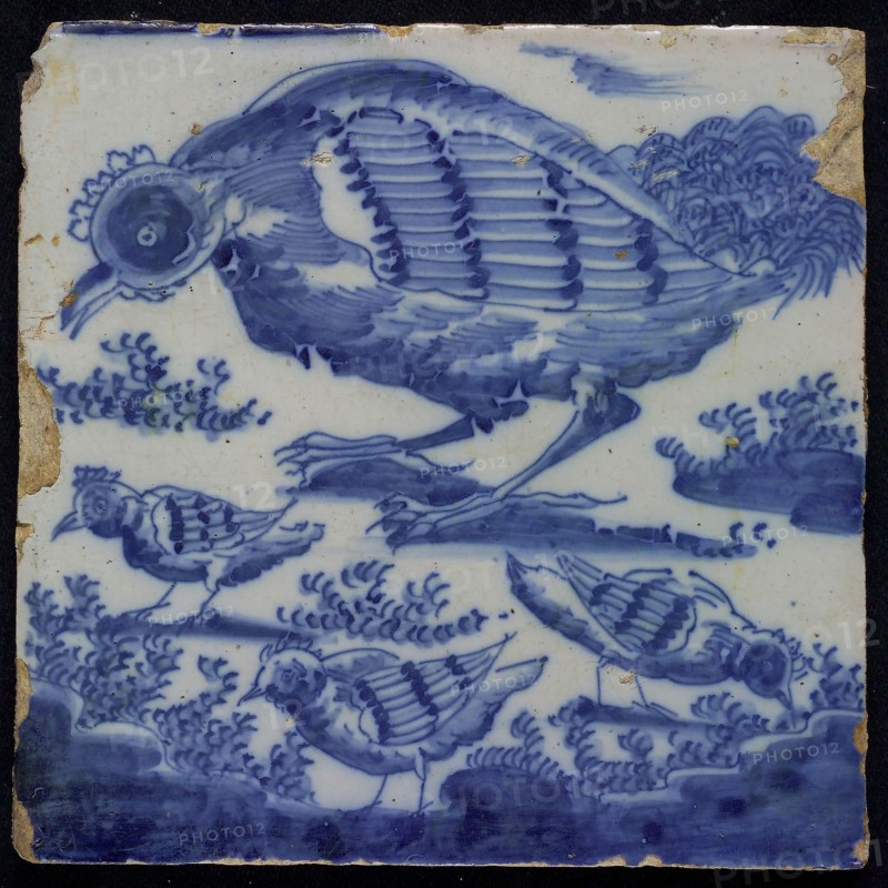 Blue tile with chicken and chicks, foot of chimney pilaster of 13 tiles, tree of bunches of grapes, between which some birds