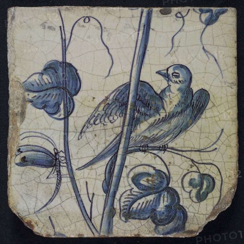 Blue tile with looking bird to dragonfly, on grape leaf of chimney pilaster with 13 tiles, tile pilaster footage fragment earth