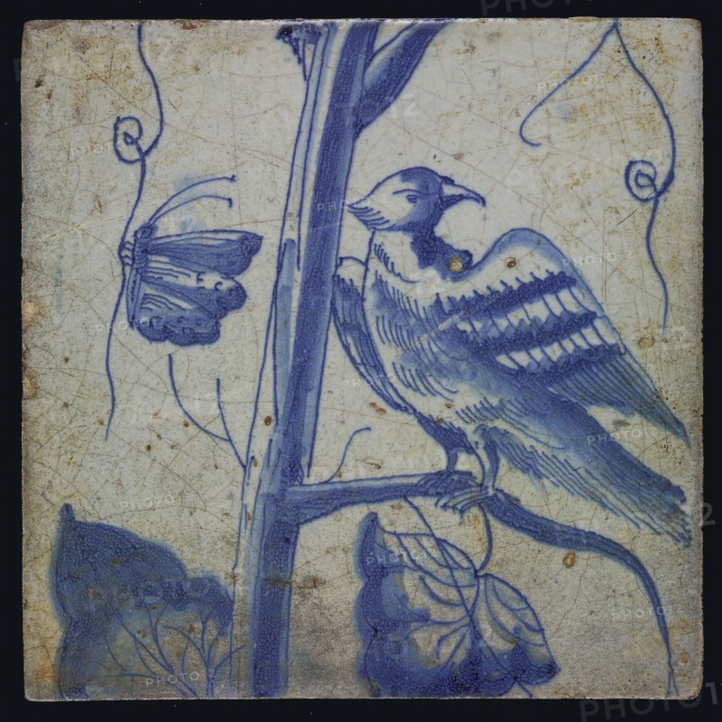 Blue tile with looking bird on grape leaf, butterfly, of chimney pilaster with 13 tiles, tree of bunches of grapes with birds
