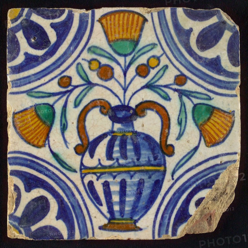 Tile, blue draft, orange, yellow, brown and green on white, central flowerpot with marigolds, corner pattern, rosette, wall tile