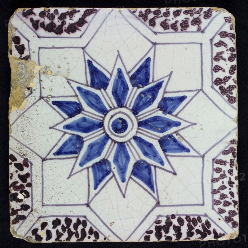 Sprinkled ornament tile, center double circle, double eight-pointed blue star, against background of two white eight-pointed