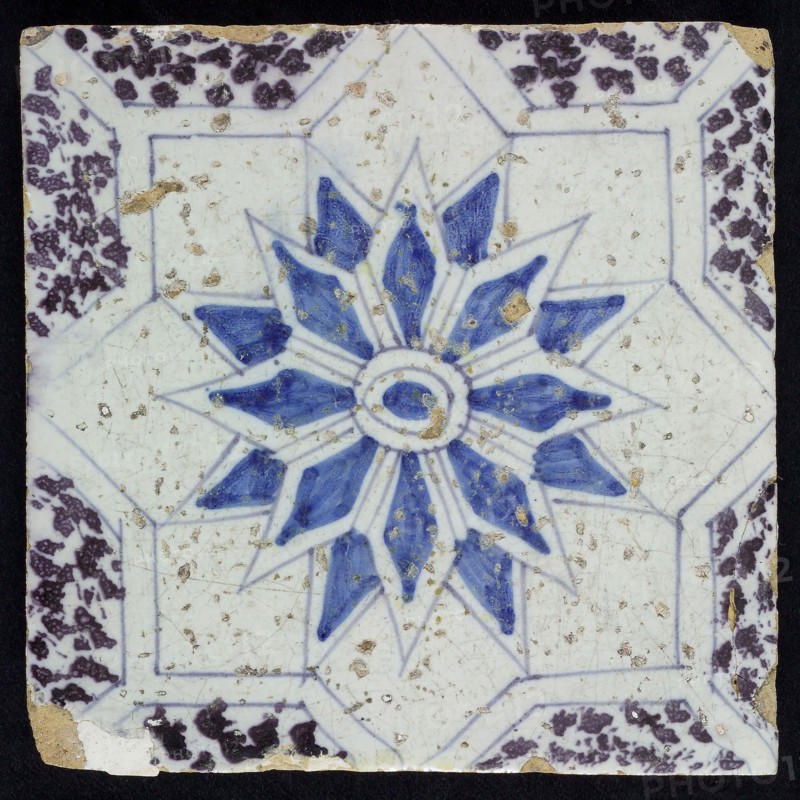 Sprinkled ornament tile, center double circle, double eight-pointed blue star, against background of two white eight-pointed