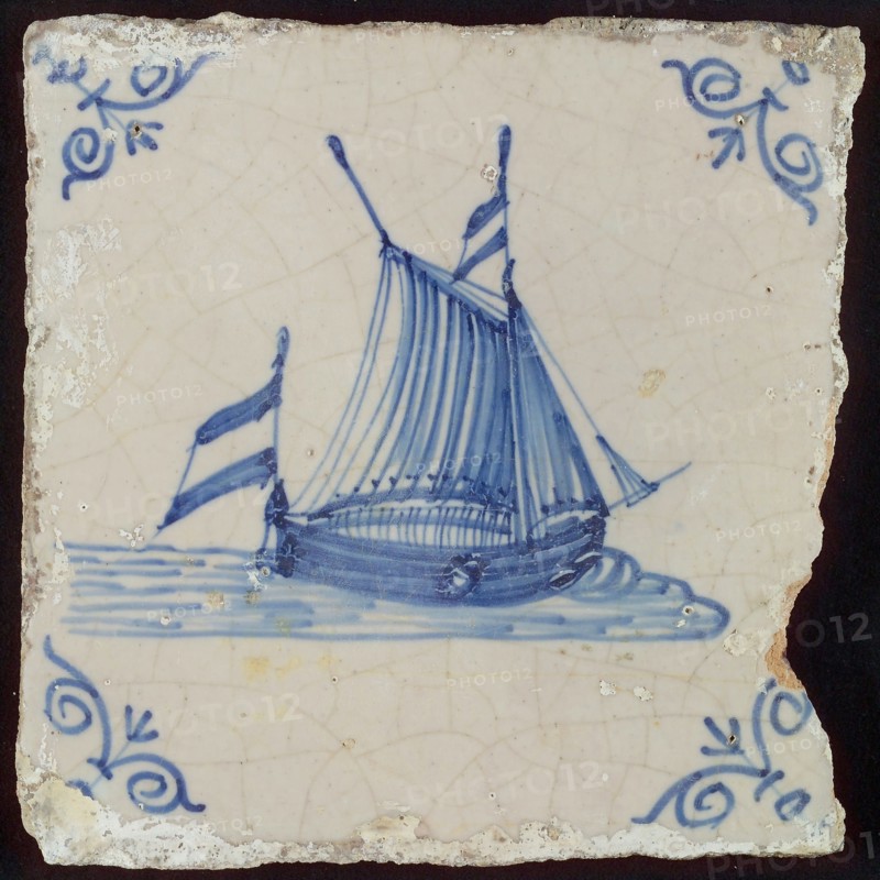 Scene tile, sailing flat bottom with full sails, corner motif of ox's head, wall tile tile sculpture ceramic earthenware glaze