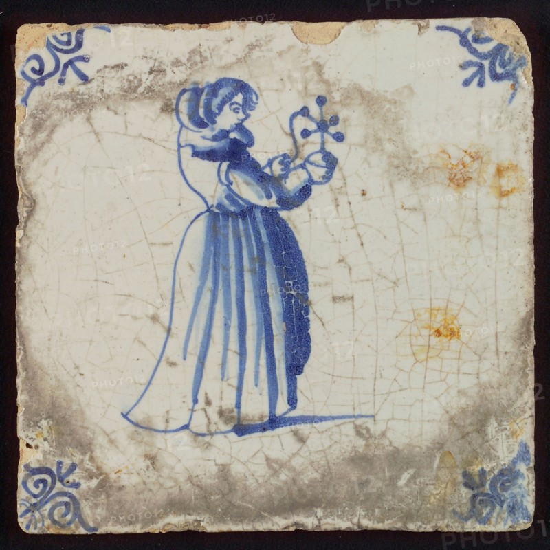 Scene tile, child's play, child with windmill, corner motif ox's head, wall tile tile sculpture ceramic earthenware glaze, baked