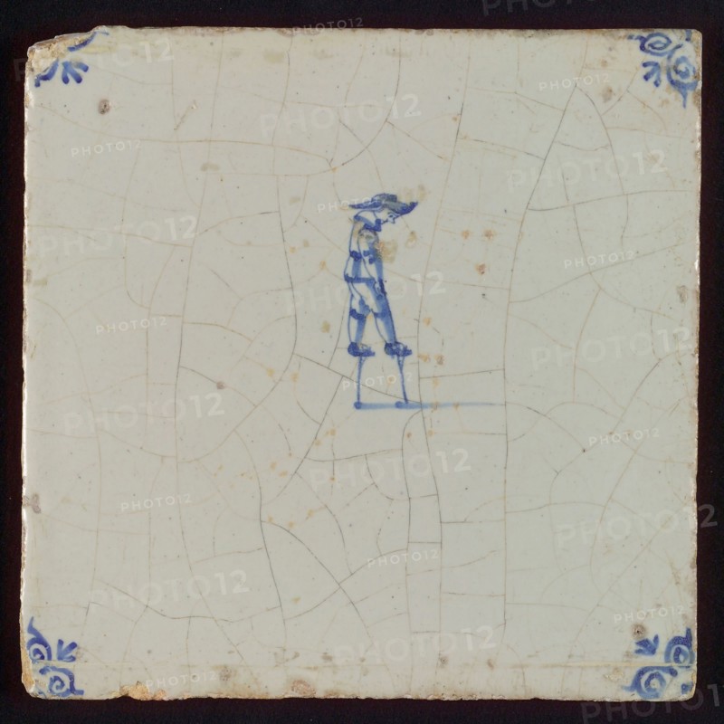 Scene tile, child's play, child on stilts, corner motif ox's head, wall tile tile sculpture ceramics pottery glaze tin glaze