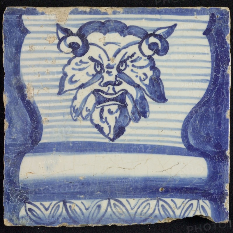 Tile of chimney pilaster, blue on white, part of striped column with base on which horned lion's head, floral border, chimney