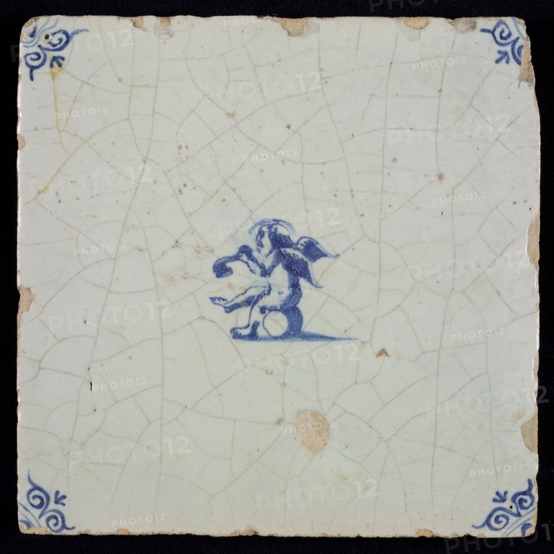 White tile with blue seated putto; corner pattern ox head, wall tile tile sculpture ceramic earthenware glaze, baked 2x glazed