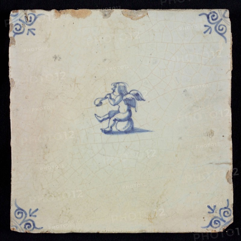 White tile with blue seated putto; corner pattern ox head, wall tile tile sculpture ceramic earthenware glaze, baked 2x glazed