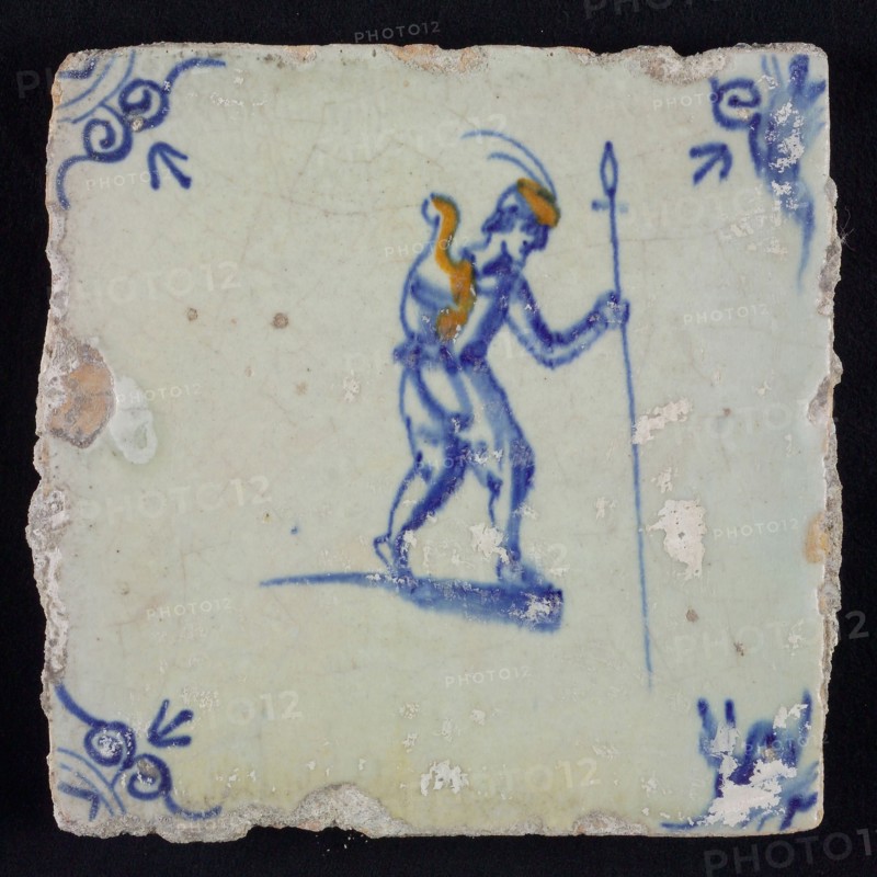 White tile with yellow and blue man with spear and shield, Ox-head corner motif, wall tile tile sculpture ceramic earthenware