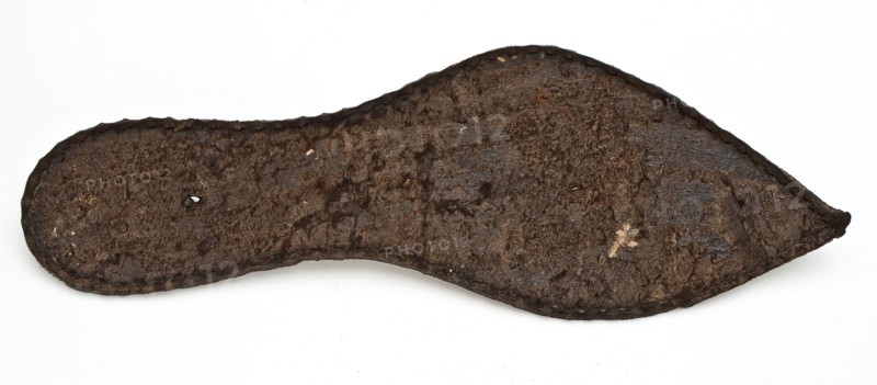 Shoe fragment, consisting of pointy sole of the left shoe, rather small size, sole shoe footwear clothing part soil finding