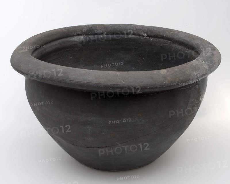 Black storage jar on standing surface, folded top edge above constriction, storage jar pot holder soil found ceramic earthenware