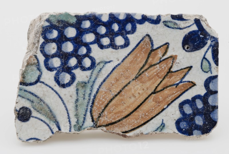 Fragment earthenware tile from quatrefoil with polychrome tulip and bunch of grapes, wall tile tile footage earth discovery