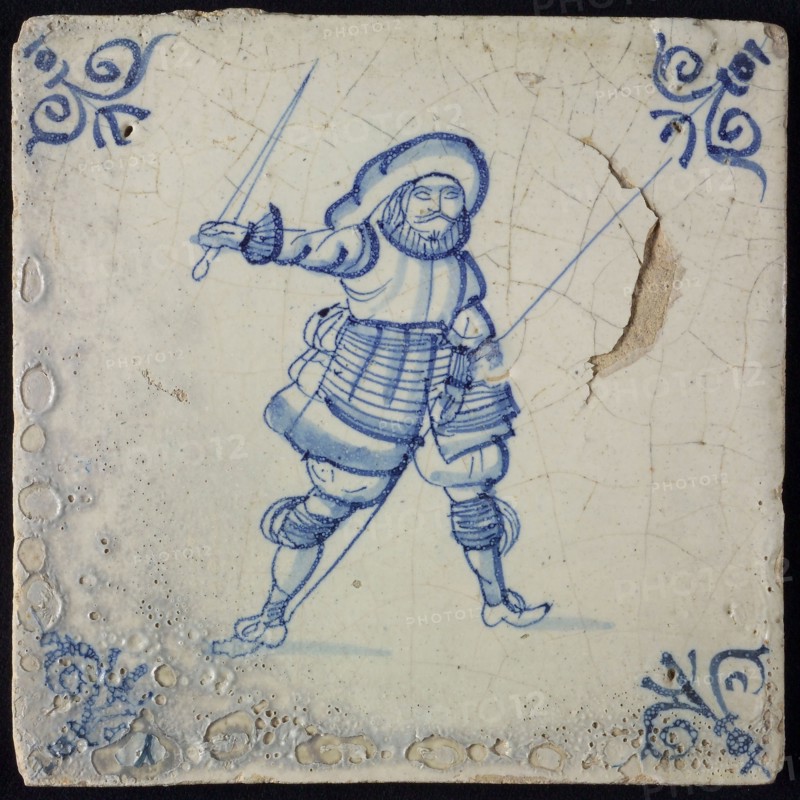 White tile with blue warrior with sword and spear; corner pattern ox head, wall tile tile sculpture ceramic earthenware glaze