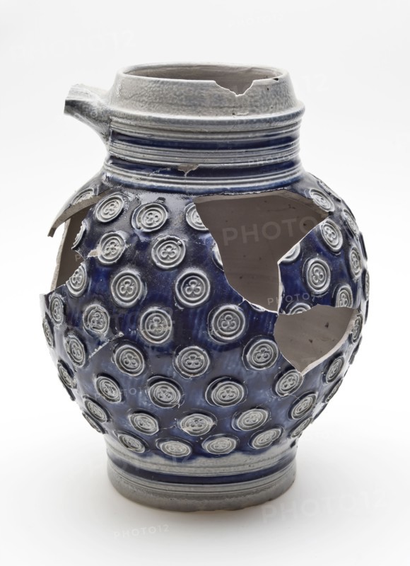 Stoneware jug decorated with small rosettes on blue background, jug crockery holder soil find ceramic stoneware glaze salt glaze