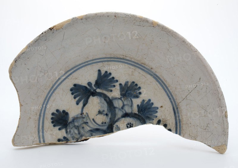 Fragment of faience plate decorated with blue decor, fruit, plate crockery holder fragment earthenware pottery earthenware glaze