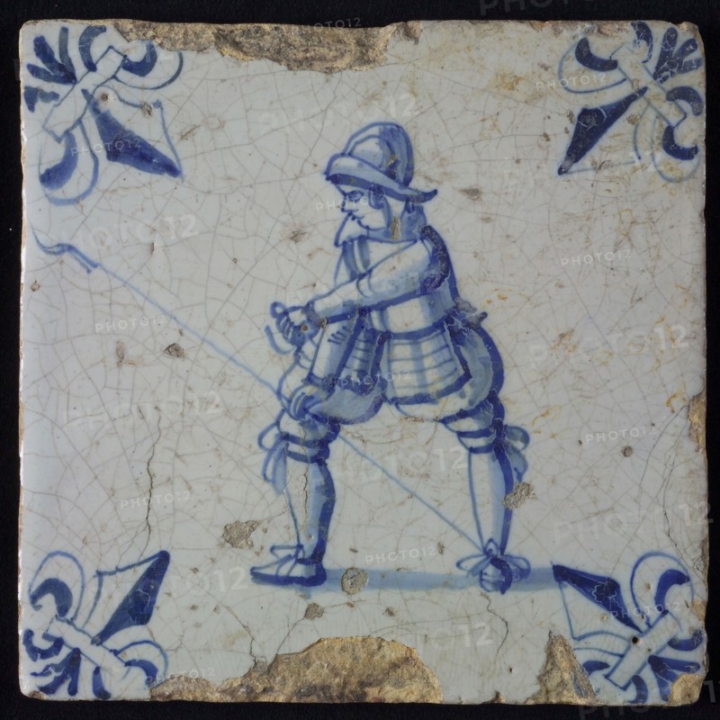 White tile with blue warrior; corner pattern lily, wall tile tile sculpture ceramic earthenware glaze, baked 2x glazed painted