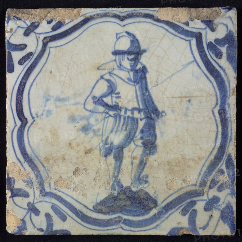 White tile with blue warrior in accolade-shaped frame, corner motif wing leaf, wall tile tile sculpture ceramic earthenware